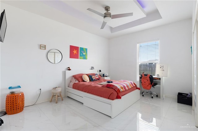 bedroom featuring a tray ceiling and ceiling fan