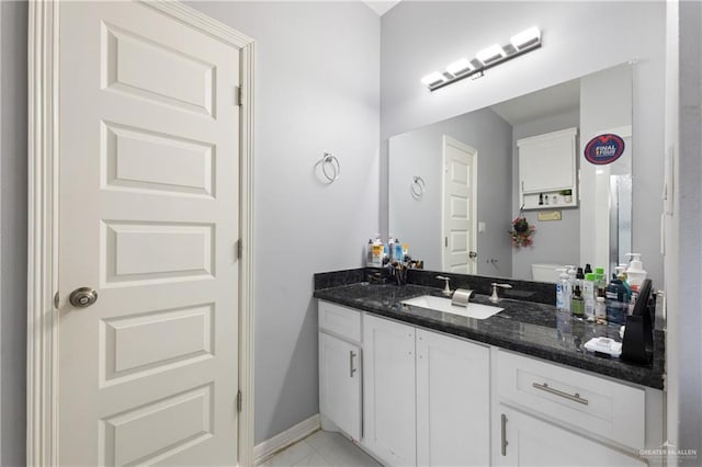 bathroom with tile patterned floors, vanity, and toilet