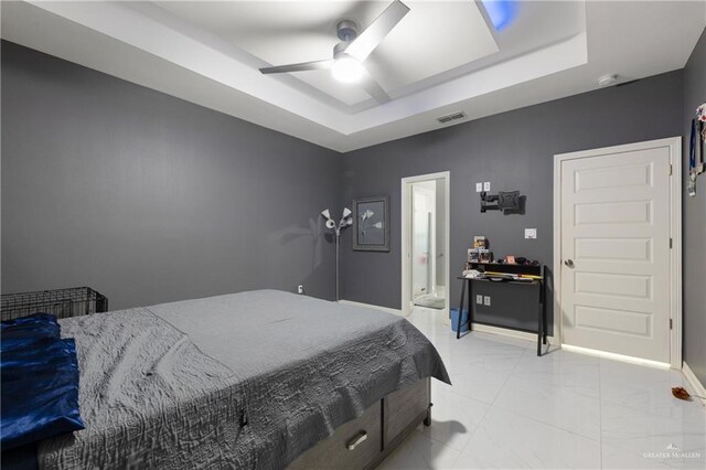 bedroom featuring a raised ceiling and ceiling fan