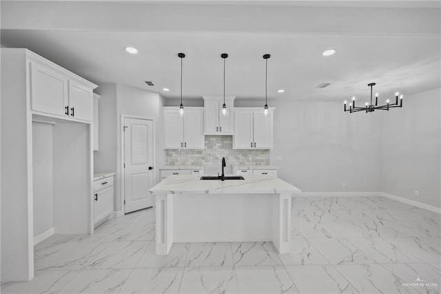 kitchen with marble finish floor, recessed lighting, backsplash, a sink, and baseboards