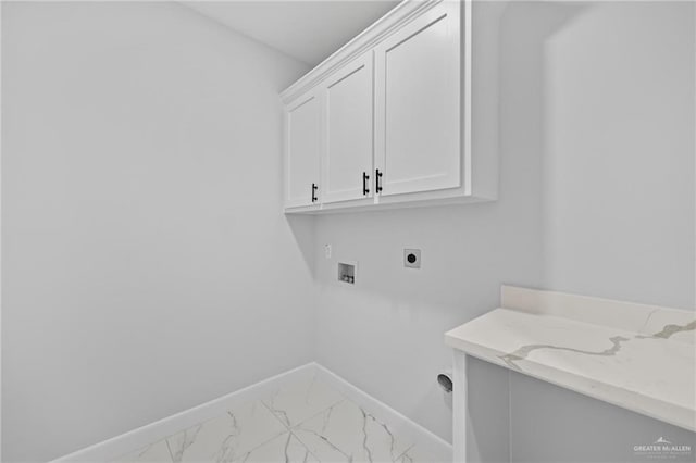 clothes washing area featuring washer hookup, marble finish floor, cabinet space, electric dryer hookup, and baseboards