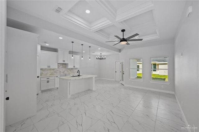 kitchen featuring coffered ceiling, marble finish floor, open floor plan, and backsplash