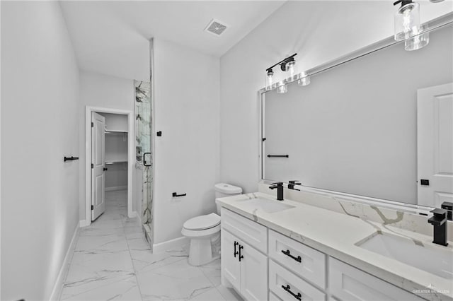 bathroom with marble finish floor, a shower stall, visible vents, and a sink