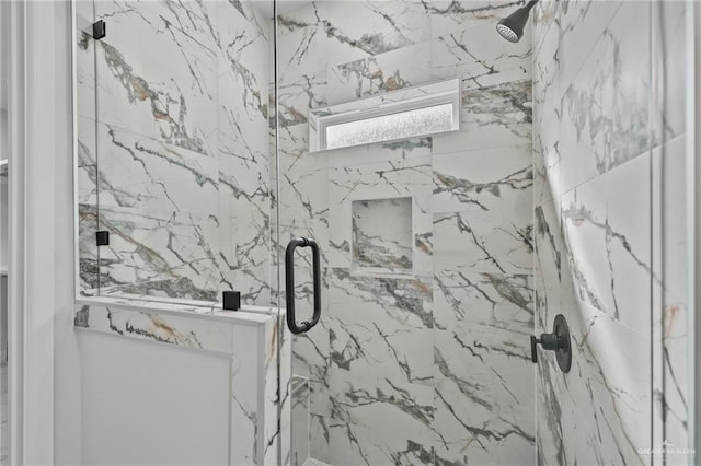 full bath with a marble finish shower