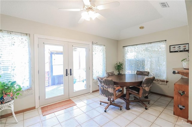 dining area featuring light tile patterned floors, french doors, visible vents, and a healthy amount of sunlight