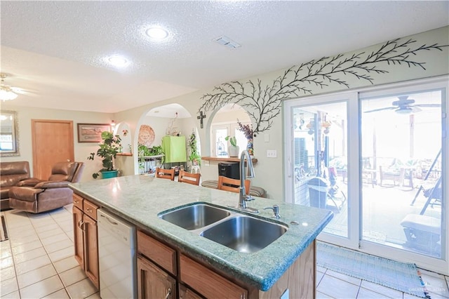 kitchen with visible vents, dishwasher, ceiling fan, open floor plan, and a sink