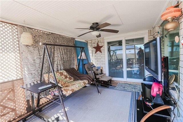 sunroom featuring ceiling fan