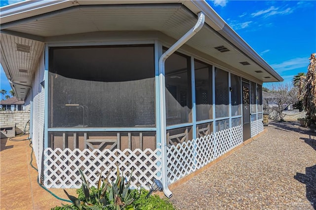 view of side of property with a sunroom