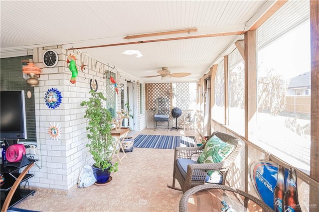 sunroom featuring plenty of natural light and a ceiling fan