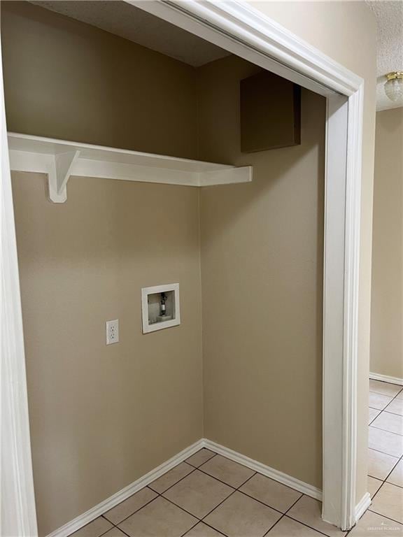 laundry room featuring washer hookup and light tile patterned flooring