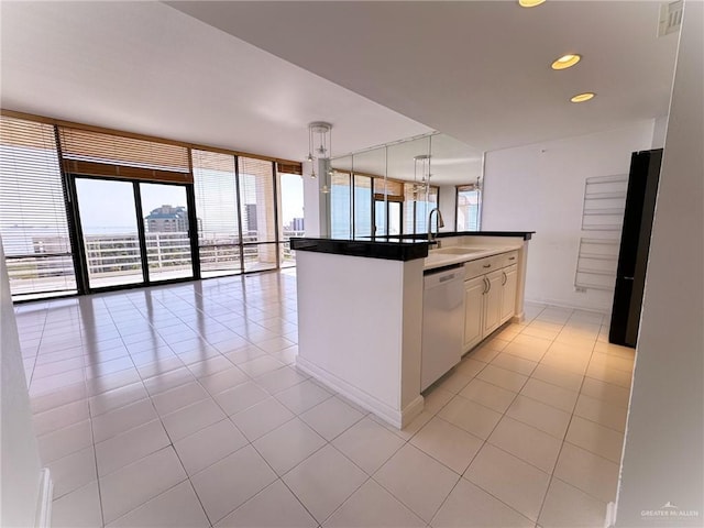 kitchen featuring sink, white cabinetry, light tile patterned floors, white dishwasher, and pendant lighting