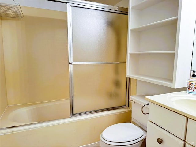 full bathroom with vanity, bath / shower combo with glass door, and toilet