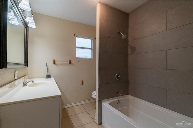 full bathroom featuring tile patterned floors, vanity, toilet, and tiled shower / bath combo