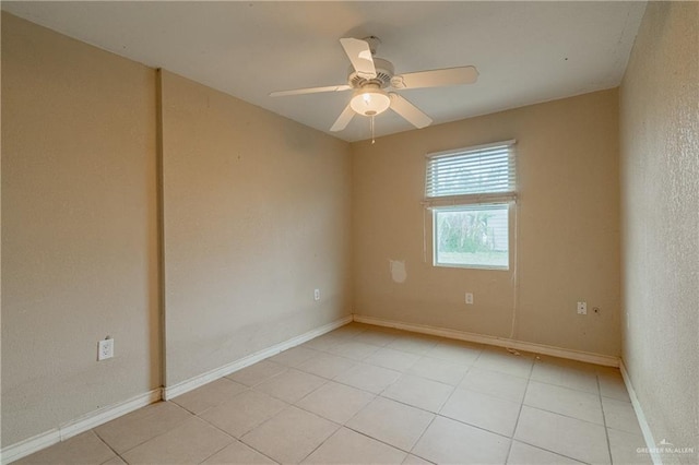 spare room featuring ceiling fan and light tile patterned flooring