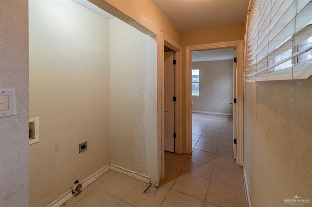 laundry area featuring hookup for an electric dryer, light tile patterned floors, and hookup for a washing machine