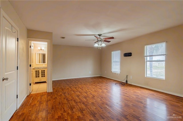 empty room featuring hardwood / wood-style floors and ceiling fan