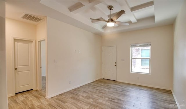 spare room featuring beamed ceiling, ceiling fan, light wood-type flooring, and coffered ceiling