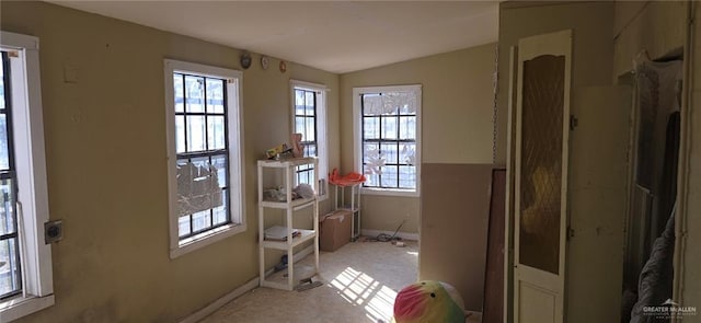 doorway to outside featuring light carpet and lofted ceiling