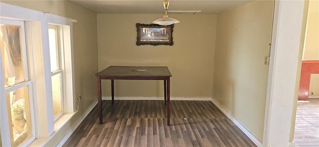 unfurnished dining area featuring dark hardwood / wood-style flooring