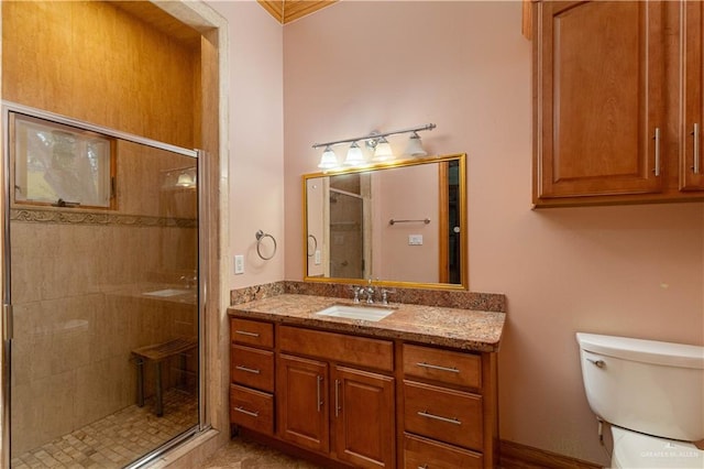 bathroom featuring tile patterned floors, a shower with door, vanity, and toilet