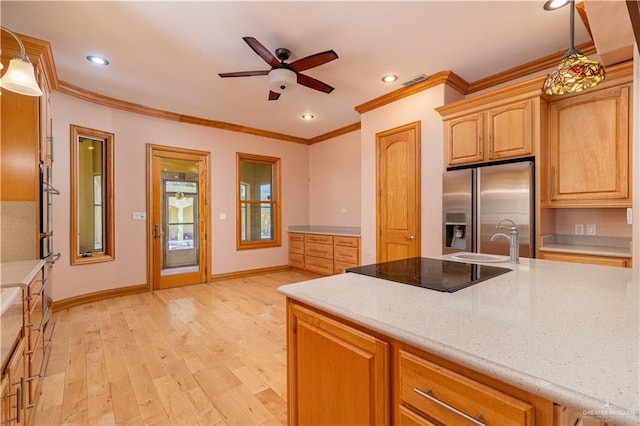 kitchen featuring appliances with stainless steel finishes, light hardwood / wood-style floors, hanging light fixtures, and ceiling fan