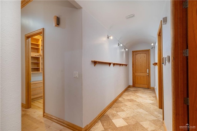 hall featuring vaulted ceiling