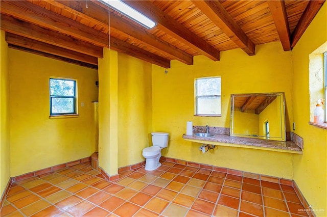 bathroom with tile patterned floors, wood ceiling, sink, beam ceiling, and toilet