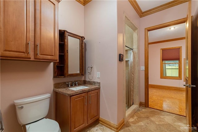 bathroom with vanity, toilet, ornamental molding, and walk in shower