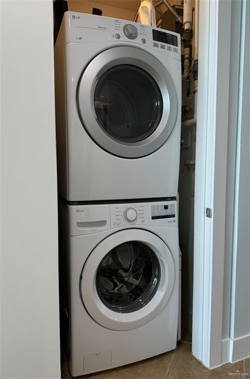 310A Padre Blvd Unit 1305, South Padre Island, TX 78597 - laundry room featuring estacked washer and dryer and tile patterned flooring