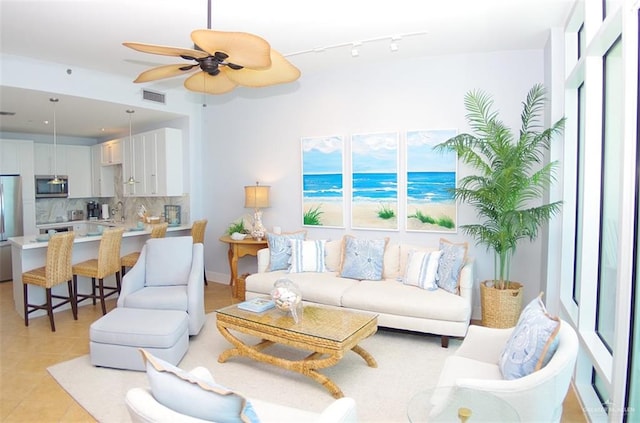 310A Padre Blvd Unit 1305, South Padre Island, TX 78597 - living area featuring a ceiling fan, light tile patterned floors, and rail lighting