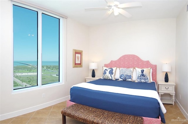 310A Padre Blvd Unit 1305, South Padre Island, TX 78597 - bedroom featuring tile patterned floors, baseboards, a water view, and a ceiling fan