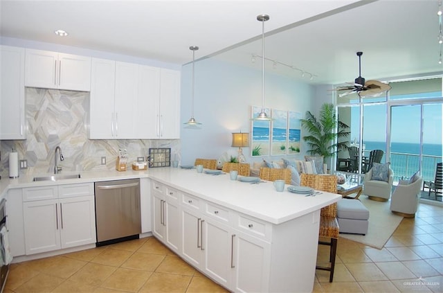 310A Padre Blvd Unit 1305, South Padre Island, TX 78597 - kitchen with stainless steel dishwasher, a sink, a peninsula, open floor plan, and ceiling fan