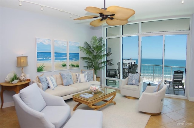 310A Padre Blvd Unit 1305, South Padre Island, TX 78597 - living room with tile patterned floors, ceiling fan, a water view, and rail lighting