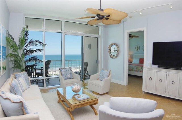 310A Padre Blvd Unit 1305, South Padre Island, TX 78597 - living room featuring a ceiling fan, light tile patterned floors, rail lighting, and baseboards