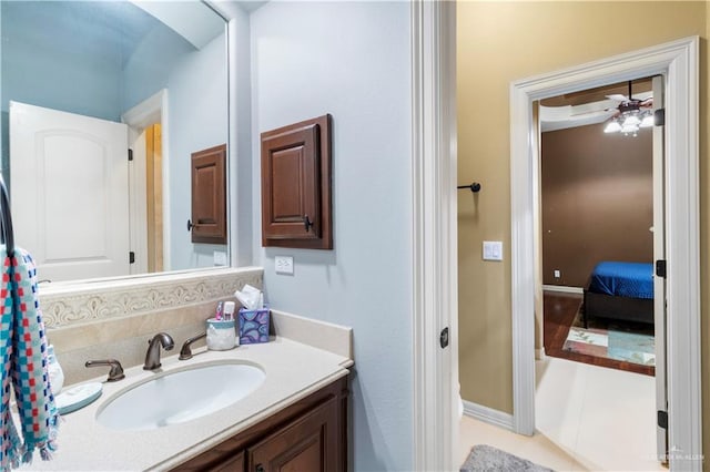 bathroom with tile patterned flooring, vanity, and ceiling fan