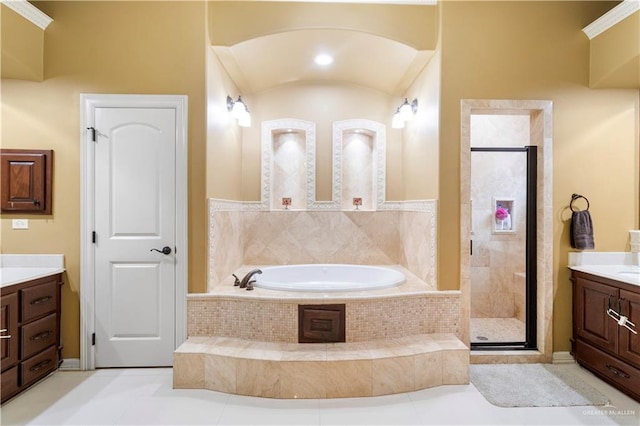 bathroom featuring tile patterned flooring, vanity, and plus walk in shower