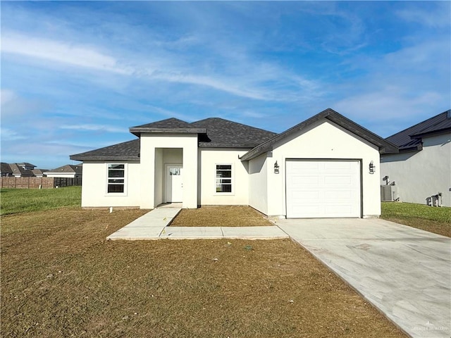 view of front facade with central AC unit, a garage, and a front lawn