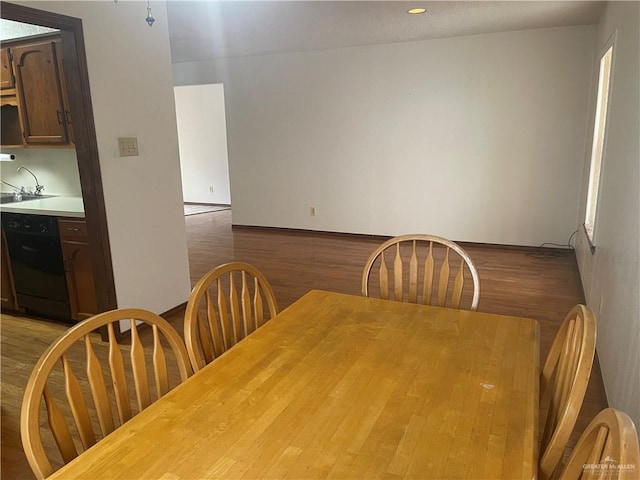 dining area featuring wood-type flooring and sink