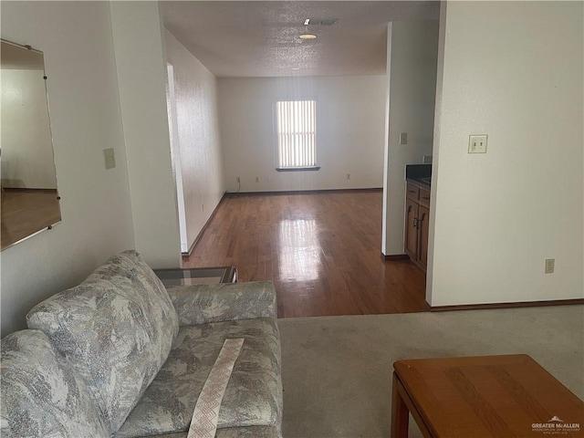 living room with hardwood / wood-style flooring and a textured ceiling