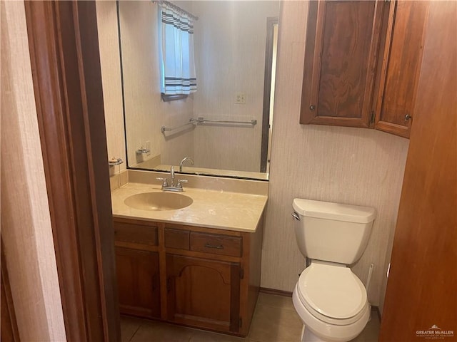 bathroom with tile patterned flooring, vanity, and toilet