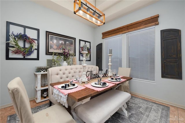 dining room with arched walkways and baseboards