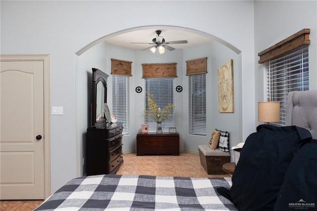 mudroom featuring light tile patterned floors, ceiling fan, and arched walkways