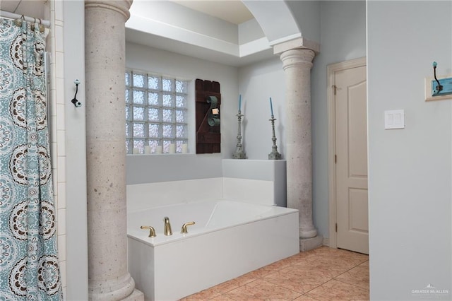 bathroom with a shower with curtain, a garden tub, decorative columns, and tile patterned floors