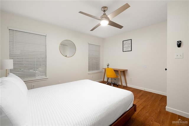 bedroom featuring ceiling fan, wood finished floors, and baseboards