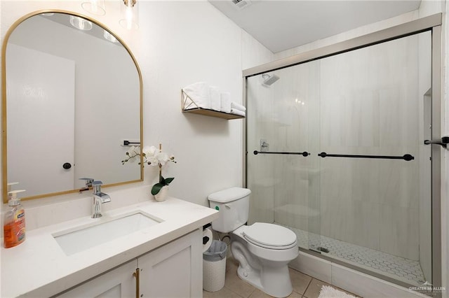 full bath featuring toilet, a stall shower, vanity, and tile patterned floors