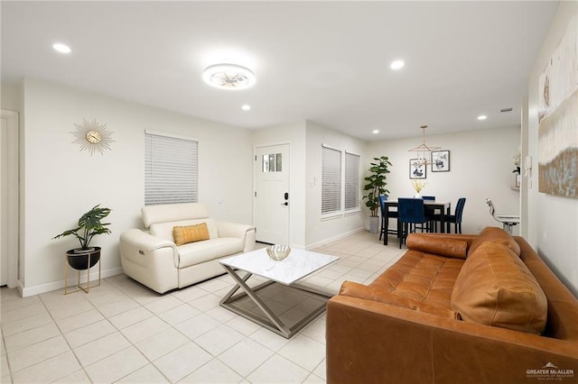 living area featuring light tile patterned floors, baseboards, and recessed lighting