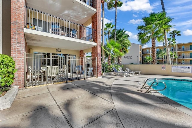 view of swimming pool with a patio area