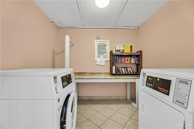 clothes washing area with separate washer and dryer and light tile patterned floors