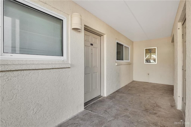 doorway to property featuring a patio area