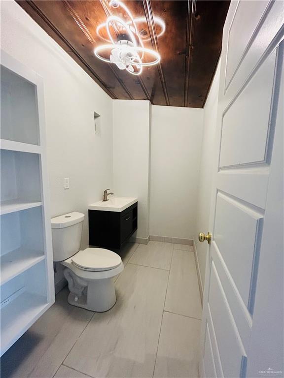 612 E Tom Landry St, Mission, TX 78572 - half bathroom featuring tile patterned flooring and a chandelier